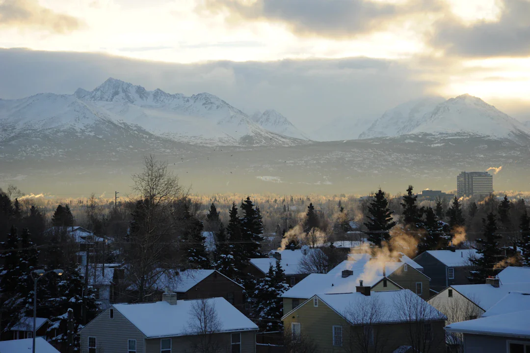 Snowy Anchorage neighborhood with the Chugach Mountains behind it